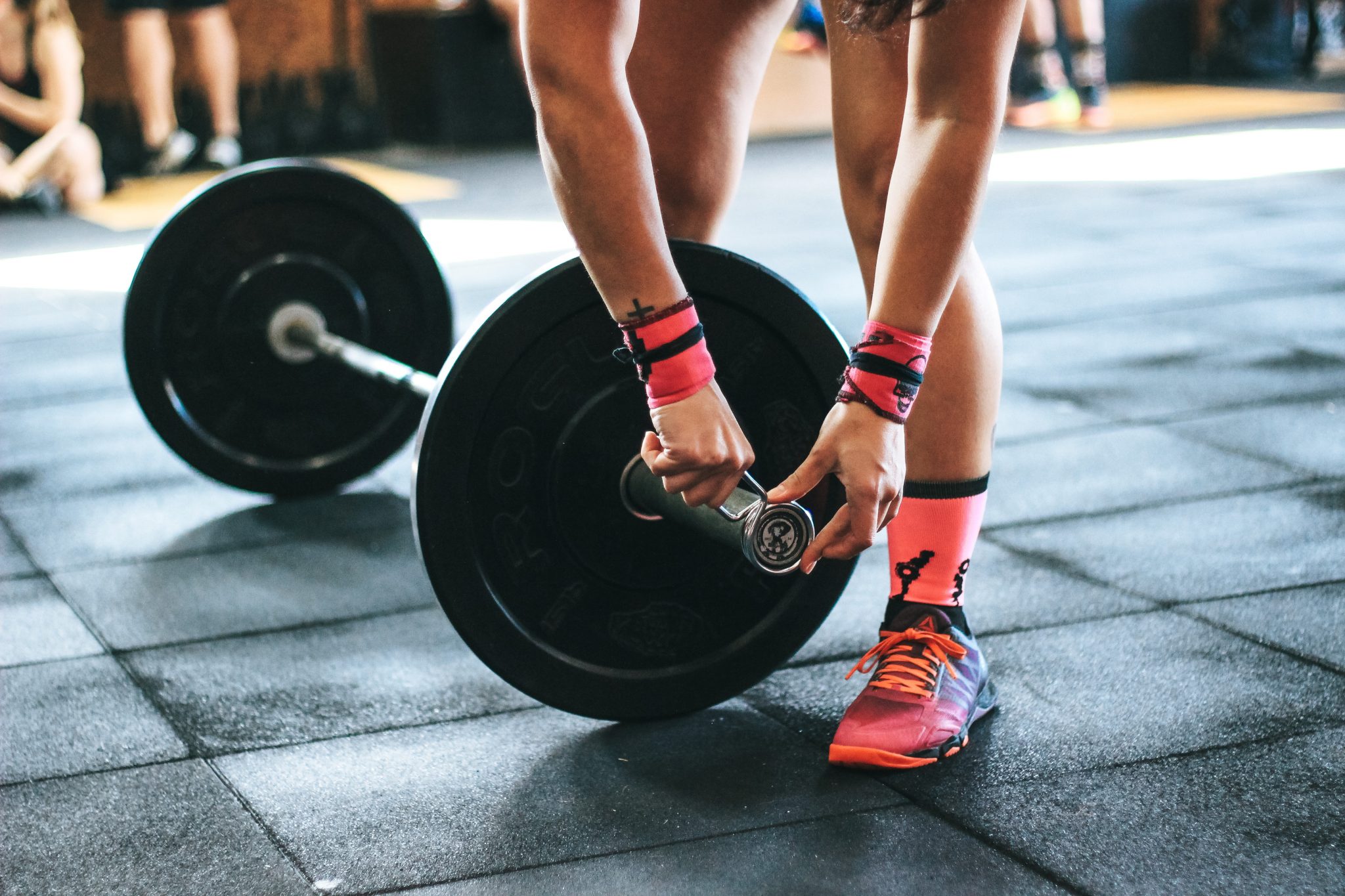 Loading more weight on the barbell to get stronger.